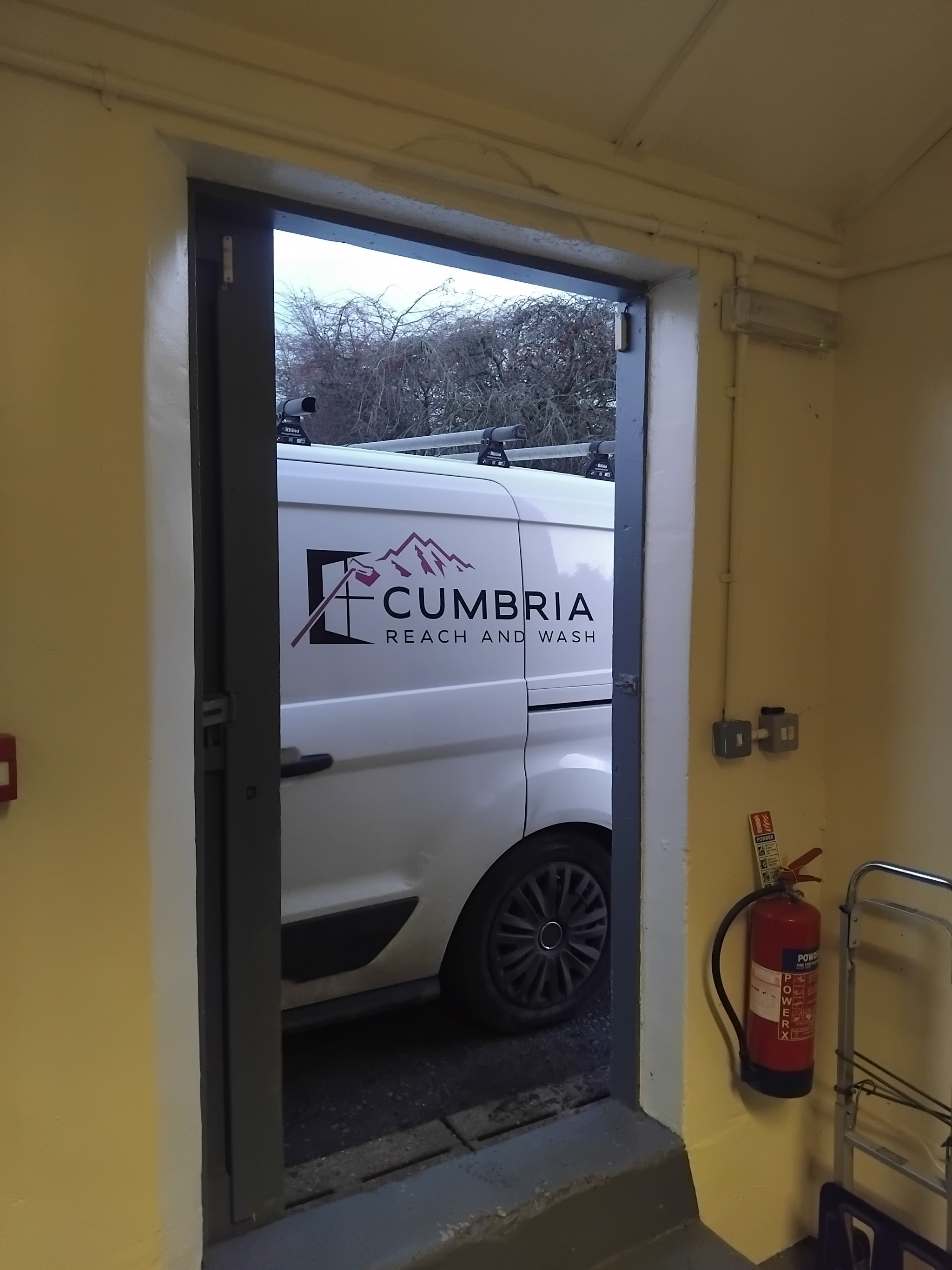 A Cumbria Reach and Wash van seen through an open doorway